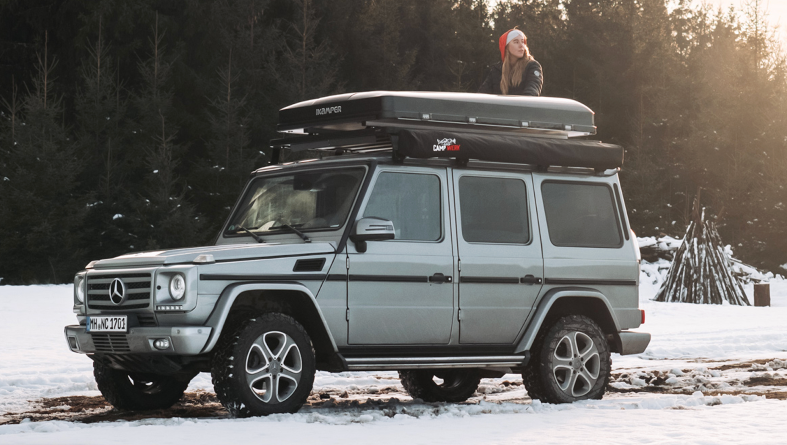 Woman with Santa hat sitting on her roof tent